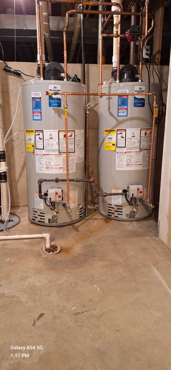Gas piping manifold with copper and black iron pipe installed along a residential wall