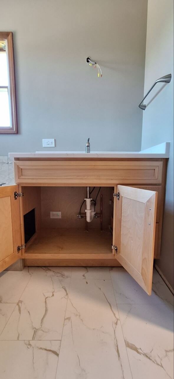 Bathroom vanity faucet installation with cabinet plumbing