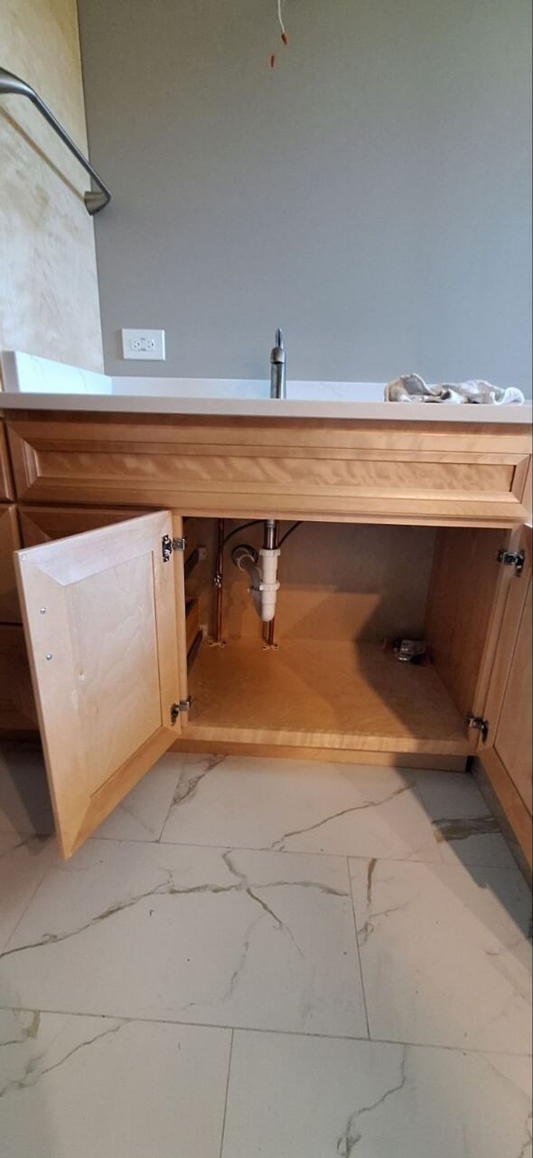 Bathroom vanity faucet and cabinet plumbing installation