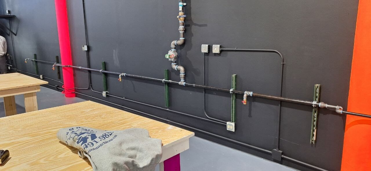 New plumbing rough-in with copper and PVC lines in new construction